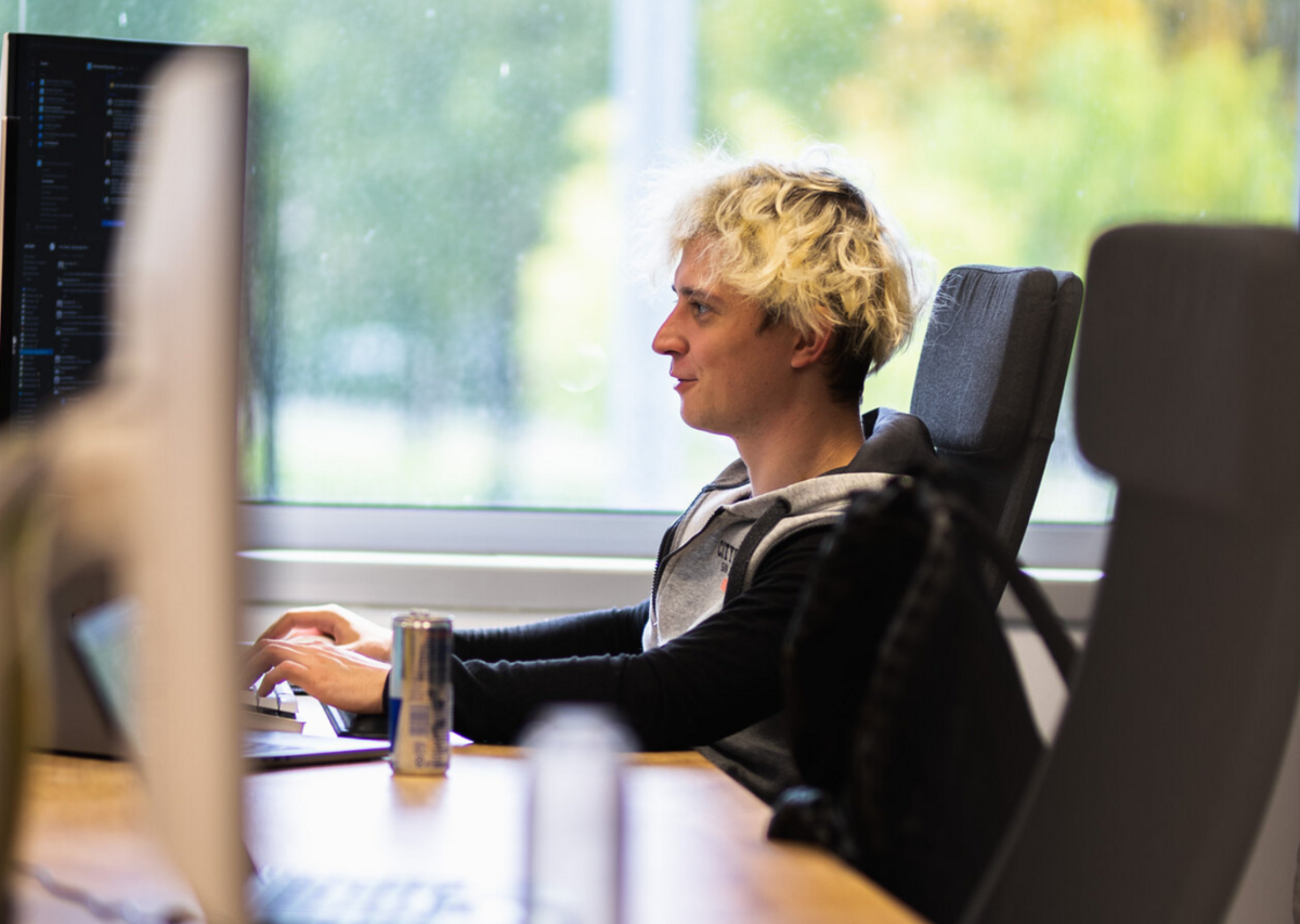 a person sitting at a desk with a computer